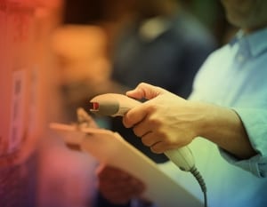 man scanning barcode on box